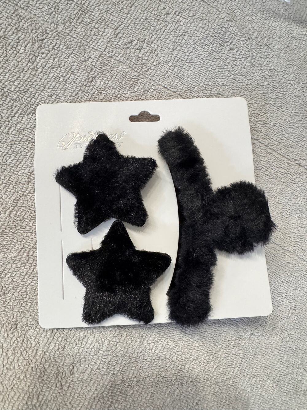 Black faux fur hair clips set with two star-shaped clips and one large clip claw